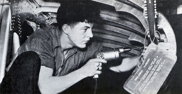 "Big planes aren't stamped out like saucepans. Thousands of parts must be fabricated and fitted by hand. Here, a workman, crouched in the leading edge of a Boeing Clipper wing, drills drills one of several hundred thousand rivet holes."