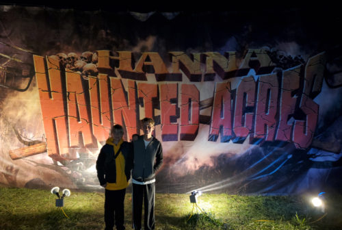 Kyle and Connor Brownfield in front of the Haunted-Acres sign.