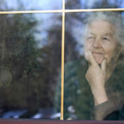 elderly woman looking out a window