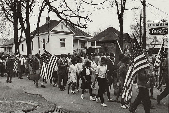 Participants, some carrying American flags, marching in the civil rights march from Selma to Montgomery, Alabama in 1965. (Image courtesy of Library of Congress)