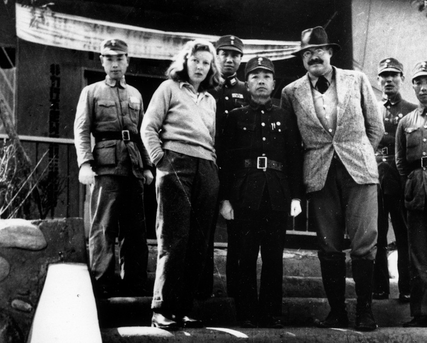 Martha Gellhorn and Ernest Hemingway pose with soldiers in Chungking