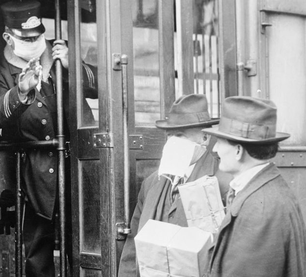 People wear surgical masks as they board a street car during the flu pandemic