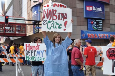 On September 12, 2009, in Minneapolis, opponents held placards outside the Target Center while President Obama delivered a healthcare speech inside. 