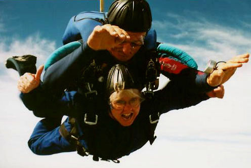 Linda (bottom) gives the camera a thumbs up as she and her instructor Pete (top) free fall from the plane. <br /> Photo taken by Skydive Miami. 