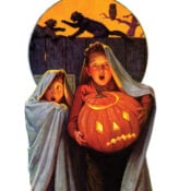 Two young boys holding a large jack-o'-lantern look utterly frightened as, behind them in silhouette, two cats argue on top of a fence while an owl looks on.