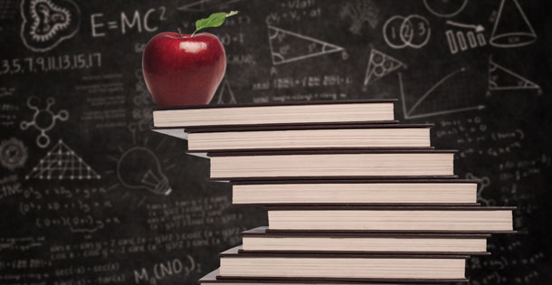 Apple education symbol and stack of books in classroom with written board
