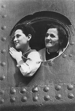 Jewish refugees aboard the SS St. Louis look out through the portholes of the ship while docked in the port of Havana. (Wikimedia Commons)