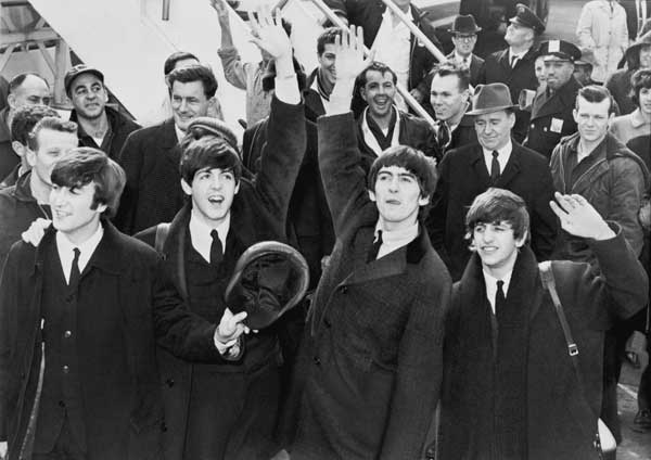 The Beatles wave to fans after arriving at Kennedy Airport on February 7, 1964. Source: United Press International, photographer unknown