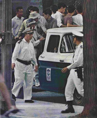 Police use truck bearing emblem of American aid program to haul students off to jail after anti-Diem demonstrations in Saigon. © Curtis Publishing Co.