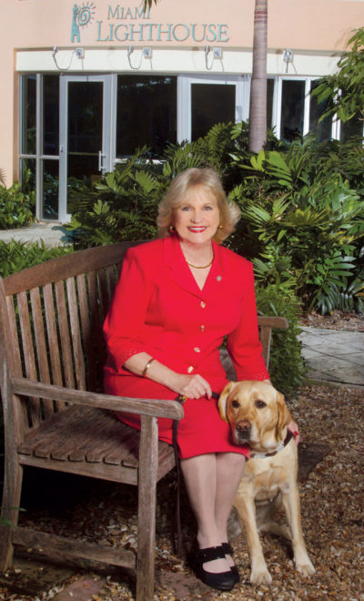 Buddies for life: President and CEO of Miami Lighthouse, Virginia Jacko, with her guide dog Tracker. (photo by Scherley Busch)