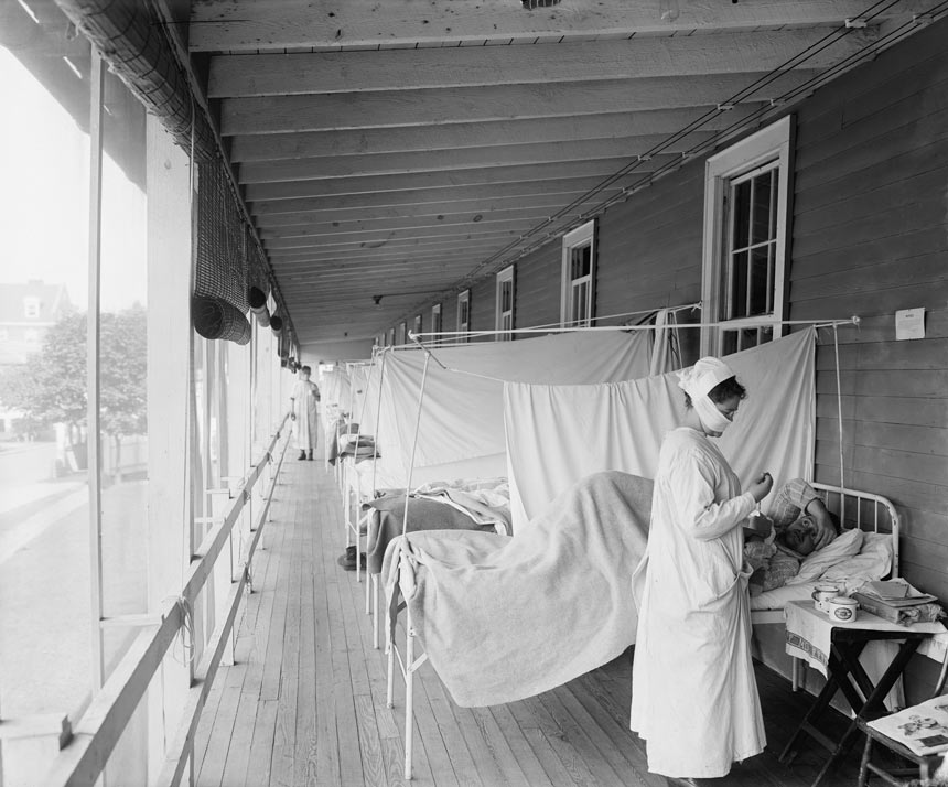 Nurse treating patients in a flu ward