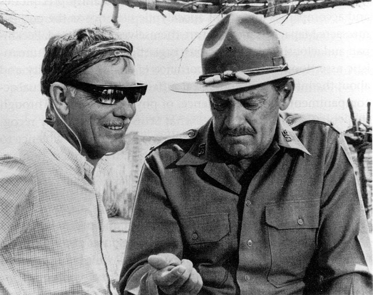 The Wild Bunch director Sam Peckinpah and actor William Holden share a moment on set.