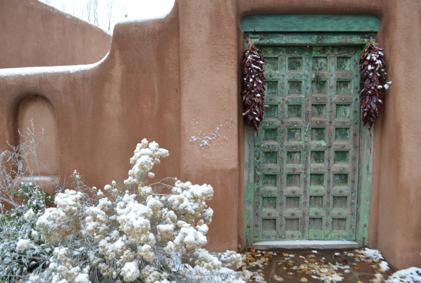 A snow covered front porch in Santa Fe