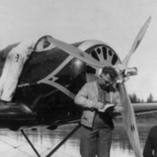 Men stand around an airplane