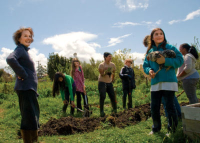Slow Food pioneer Alice Waters (left) works with students at the Edible Schoolyard in Berkeley, California. (Photo by Hannah Johnson)