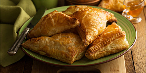 Flakey cheese pastries on a plate