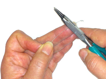 hands cutting bead wire with wire cutter