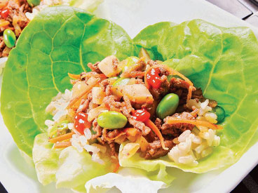 beef, carrots, and edamame set in Bibb lettuce leaf