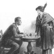 A woman talking to a seated man