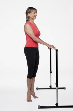 woman holding exercise bar stretching calves