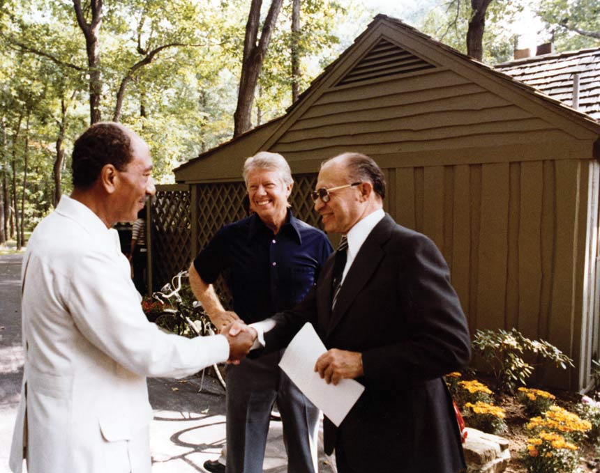 U.S. President Jimmy Carter, Egyptian President Anwar Sadat, and Israeli Prime Minister Menachem Begin greet eachother at Camp David