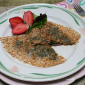 mushroom and spinach chickpea crepe with strawberry garnish