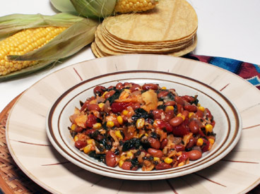 plate of chilaquiles with corn and tortillas