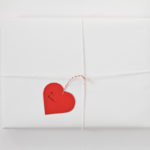 heart-shaped gift tag tied onto package