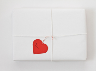 heart-shaped gift tag tied onto package