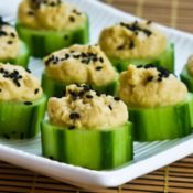 Cucumber hummus appetizer bites with sesame seeds.
