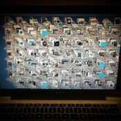 A MacBook with a very cluttered desktop