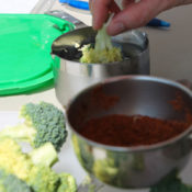 dipping broccoli in water