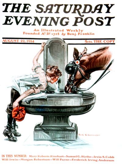 A jockey and his horse takes a drink of water out of a fountain.