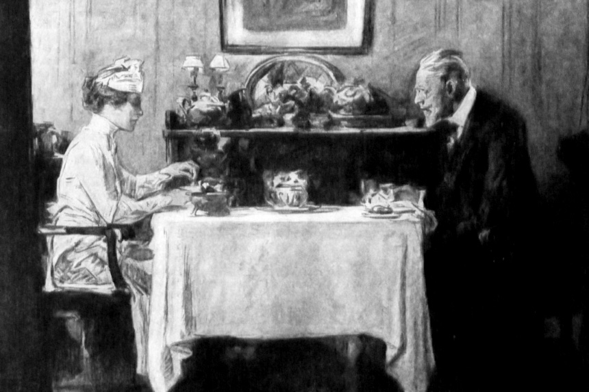 An elder man and a young woman eat at a table.