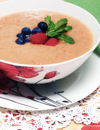 fruit soup topped with blueberries and strawberries
