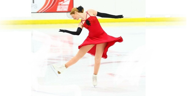 A figure skater dances on ice during a performance.