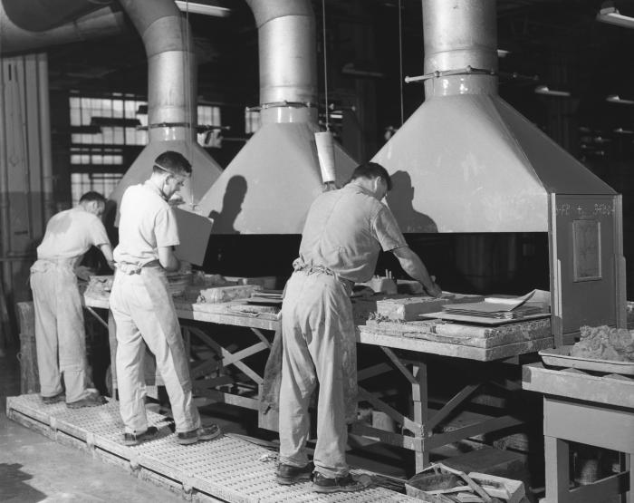 Men working with lead machinery