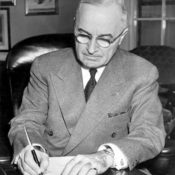 President Harry S. Truman is shown at his desk at the White House signing a proclaimation declaring a national emergency. (National Archives)