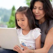 Mom and daughter at laptop. Photo by Tyler Olson via Shutterstock.