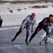 Speedskaters move on the ice.