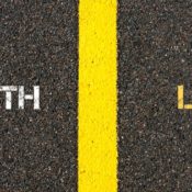 The words "Truth" and "Lie" on opposites sides of a street's yellow divider line