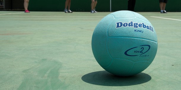 A dodgeball resting on a court