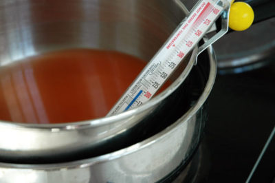 A double boiler and wax thermometer is used to heat wax to 200 degrees. Wax is combustible at high heat, even in the absence of open flames. Do not leave heating wax unattended.