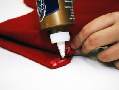 With your craft glue or hot glue gun, apply a thin bead just inside the edge of one of the stocking shapes, omitting the top (unless you don’t want any presents.)