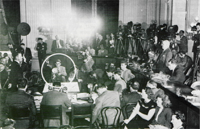 The bugaloo was everywhere. Here, the first witness is sworn in at a House Un-American Activities Committee hearing dealing with Communist influence in Hollywood. Rep. Richard M. Nixon sits to Rep. J. Parnell Thomas´s left. Left of center, the author, a <em>Post</em> photographer readies his Speed Graphic