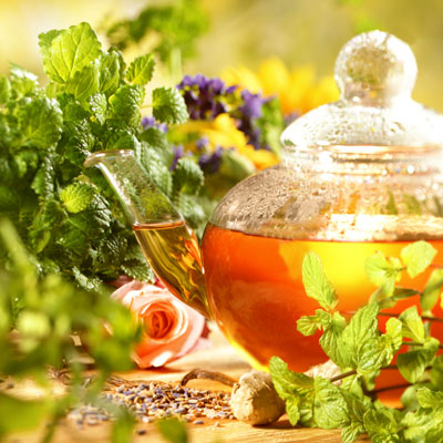 Herbal tea in a glass teapot on a warm, summer day