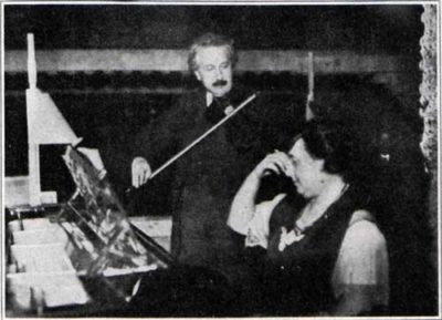 Doctor Einstein accompanying Mrs. Einstein's piano song with his violin.