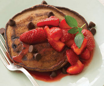 Delicious pancakes with chocolate chips and strawberries.