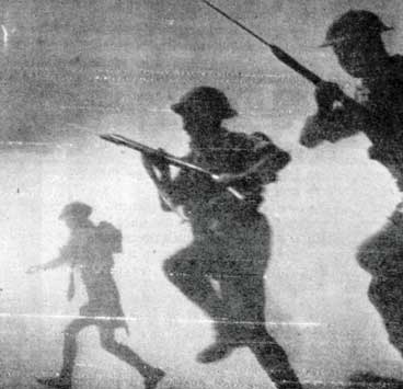 World War II British soldiers charging across the desert.