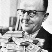 Man holding a pile of Monopoly money.